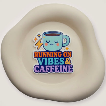 Burnt-out minds find reset with this Aussie quote sticker. Vibes & Caffeine says it all for those carrying too much, too fast.